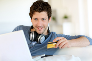 Young man shopping with credit card